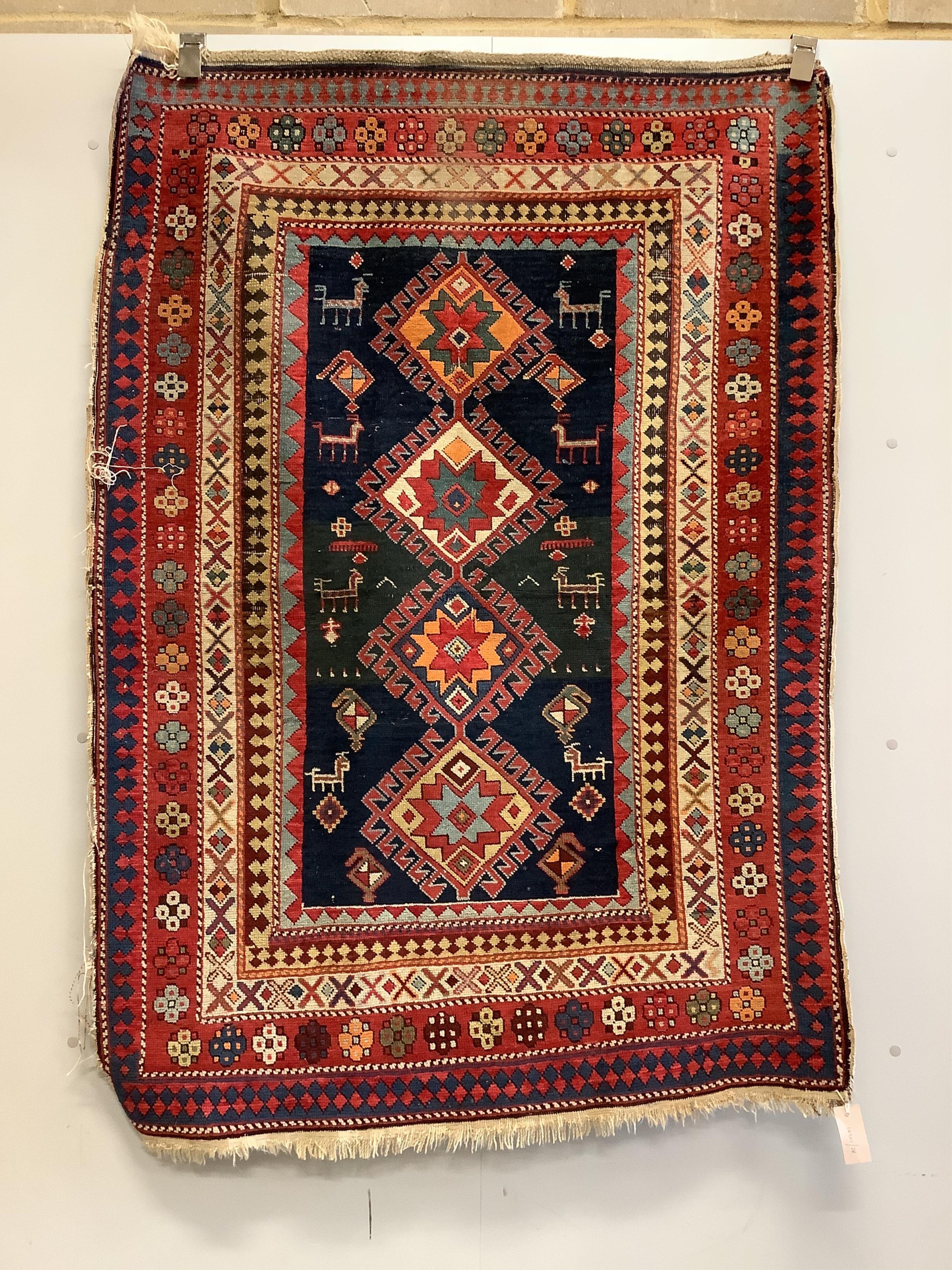 An antique Kazak blue ground rug, 150 x 109cm. Condition - fair